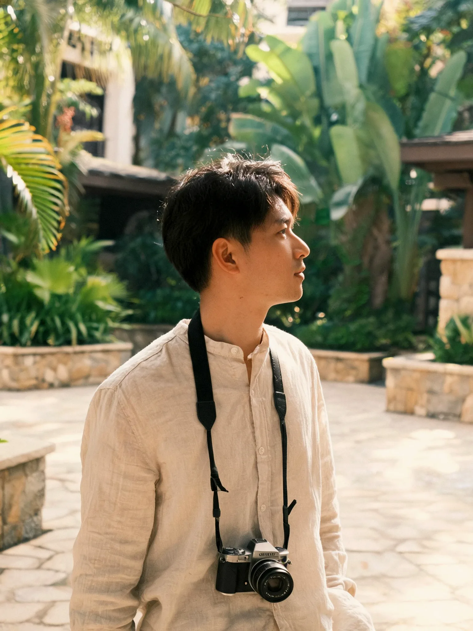 Andres Agurto with a camera in a tropical courtyard (placeholder)
