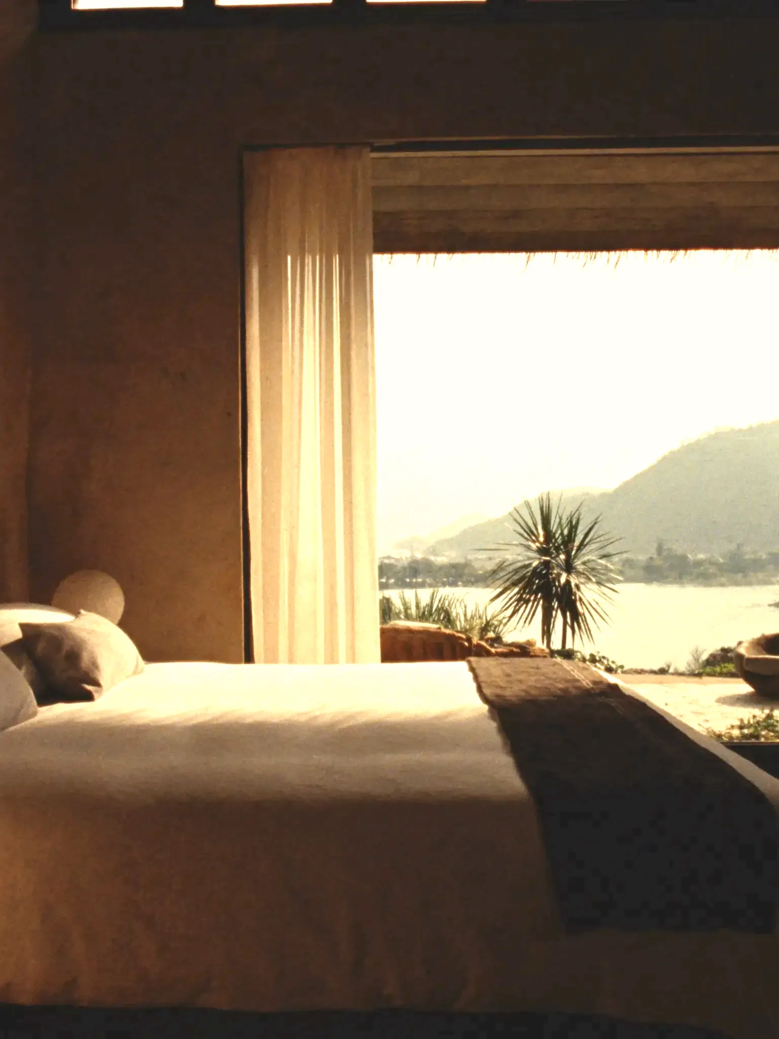 Suite with sheer curtains and a tropical view (placeholder)