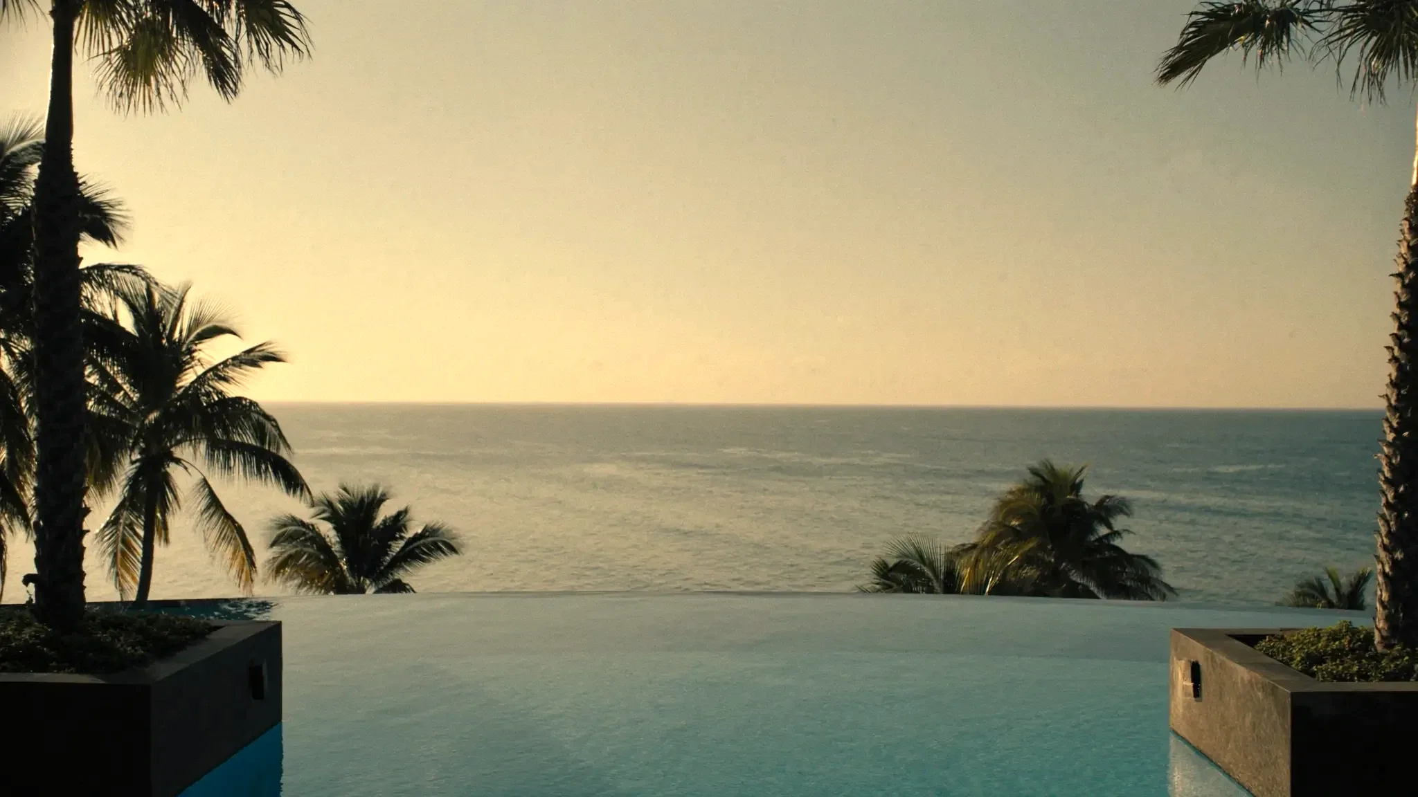 An infinity pool overlooking the ocean at golden hour (placeholder image)